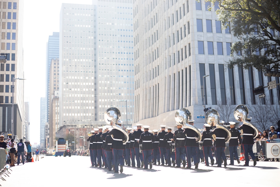 U.S. Marines with the 1st Marine Division Band participate in the Rodeo Houston Parade in downtown Houston, Texas, March 1, 2025. Marines with Western Recruiting Region, the Mounted Color Guard, and 1STMARDIV Band paraded alongside colleges, Reserve Officer Training Corps candidates, first responders, and other local organizations to kickoff the Houston Livestock Show and Rodeo. (U.S. Marine Corps photo by Sgt. Ryan H. Pulliam)