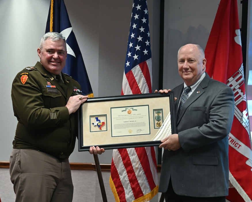 Col. Calvin Kroeger, U.S. Army Corps of Engineers' Fort Worth District commander, presents Bob Morris with the Civil Service Commendation Medal during his retirement ceremony.