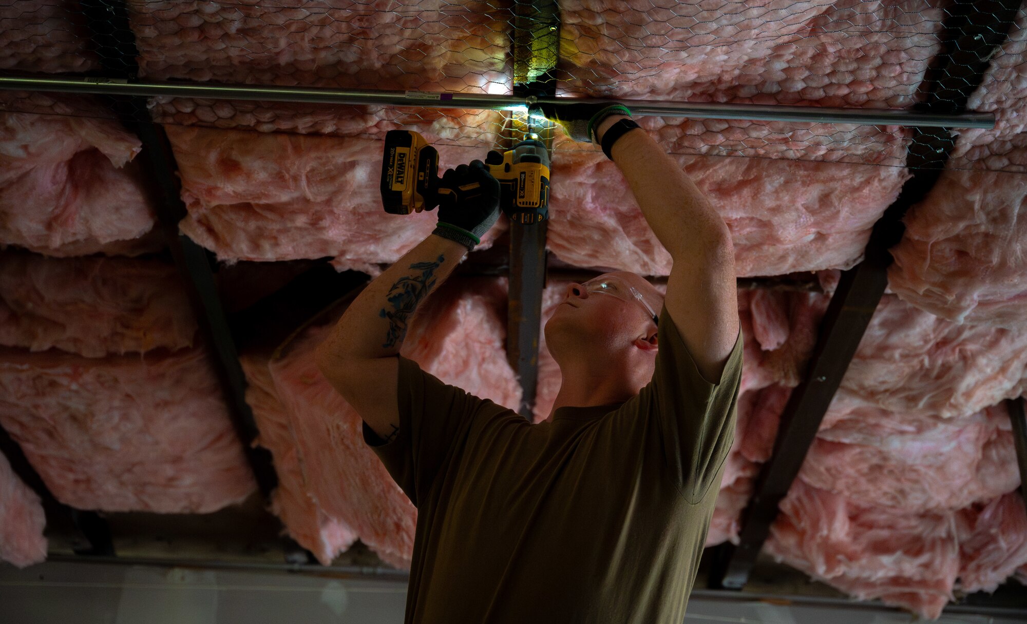 U.S Air Force Tech. Sgt. Brandon Gilmore, electrical journeyman, 445th Civil Engineer Squadron, secures a pipe to the ceiling during a deployment for training at Patrick Space Force Base, Florida, March 5, 2025. The deployment for training included Airman from the 445th CES from Wright-Patterson Air Force Base remodeling a joint warehouse space on PSFB to convert it into office space for the Requirements and Optimization office of the 45th Civil Engineer Squadron. (U.S. Space Force photo by Senior Airman Spencer Contreras)