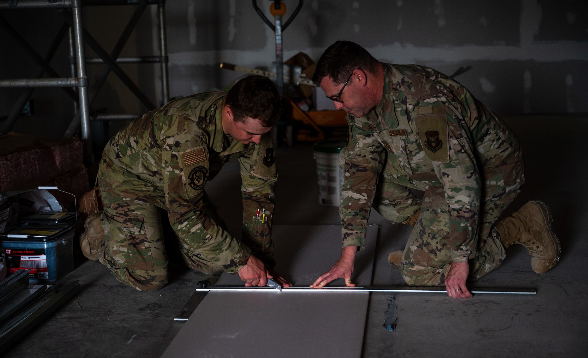 U.S. Air Force Staff Sgt. Ben Maxfield, structural journeyman, 445th Civil Engineer Squadron, right, and U.S. Air Force Senior Airman Kevin Kruger, structural journeyman, 445th Civil Engineer Squadron, cut drywall during a deployment for training at Patrick Space Force Base, Florida, March 5, 2025. The deployment for training included Airman from the 445th CES from Wright-Patterson Air Force Base remodeling a joint warehouse space on PSFB to convert it into office space for the Requirements and Optimization office of the 45th Civil Engineer Squadron. (U.S. Space Force photo by Senior Airman Spencer Contreras)