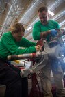 Aviation Electronics Technician 2nd Class Paige Vedra (left) and Aviation Machinist's Mate Chief Dallas Vanenkevort, both assigned to the "Spartans" of Helicopter Maritime Strike Squadron (HSM) 70, builds a main rotor head spindle aboard the world’s largest aircraft carrier, USS Gerald R. Ford (CVN 78), April 1, 2025.