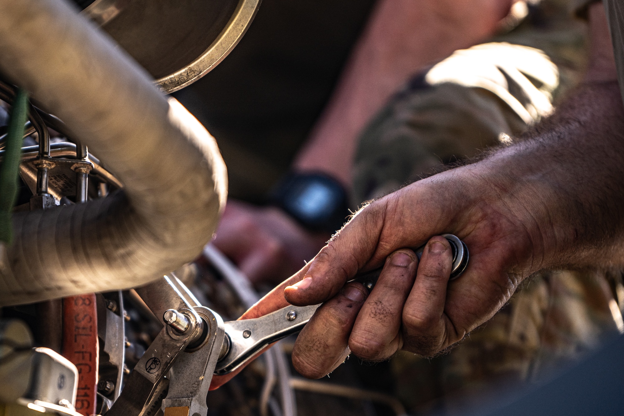 An Airman is working on an engine.