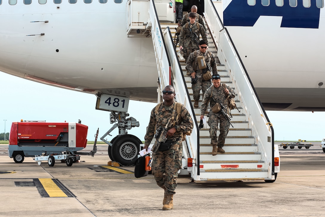 U.S. Marines and sailors with Marine Rotational Force – Darwin, deplane a Boeing 747 at Royal Australian Air Force Base Darwin, Australia, March 29, 2025. MRF-D 25.3 is part of an annual six-month rotational deployment to enhance interoperability with the Australian Defence Force and Allies and partners and provide a forward-postured crisis response force in the Indo-Pacific. (U.S. Marine Corps photo by Cpl. Anita Ramos)