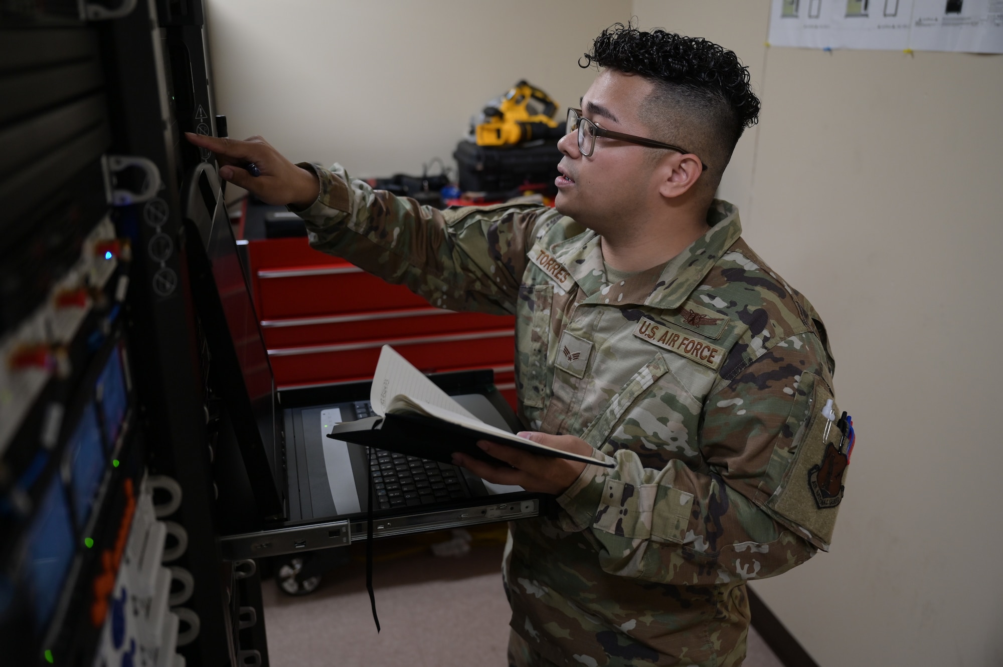 An Airman configuring a computer server.