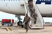 U.S. Marines and sailors with Marine Rotational Force – Darwin, deplane a Boeing 747 at Royal Australian Air Force Base Darwin, Australia, March 29, 2025. MRF-D 25.3 is part of an annual six-month rotational deployment to enhance interoperability with the Australian Defence Force and Allies and partners and provide a forward-postured crisis response force in the Indo-Pacific. (U.S. Marine Corps photo by Cpl. Anita Ramos)
