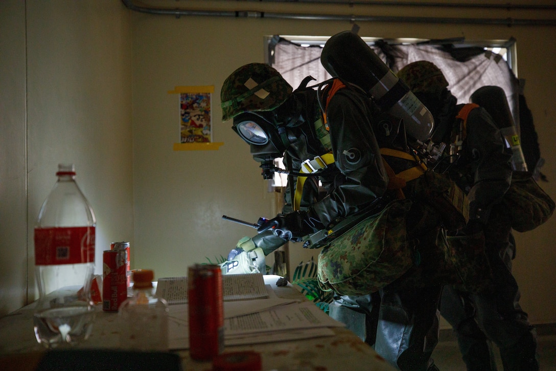 Japan Ground Self-Defense Force members with the 13th Brigade, Middle Army, perform a render safe procedure for a simulated improvised explosive device during a joint technical exchange at Marine Corps Air Station Iwakuni, Japan, March. 24, 2025. U.S. Marines from MCAS Iwakuni and JGSDF members with the 13th Brigade, Middle Army conducted a joint technical exchange to enhance their capabilities as a combined force in the Indo-Pacific. (U.S. Marine Corps photo by Lance Cpl. David Getz)