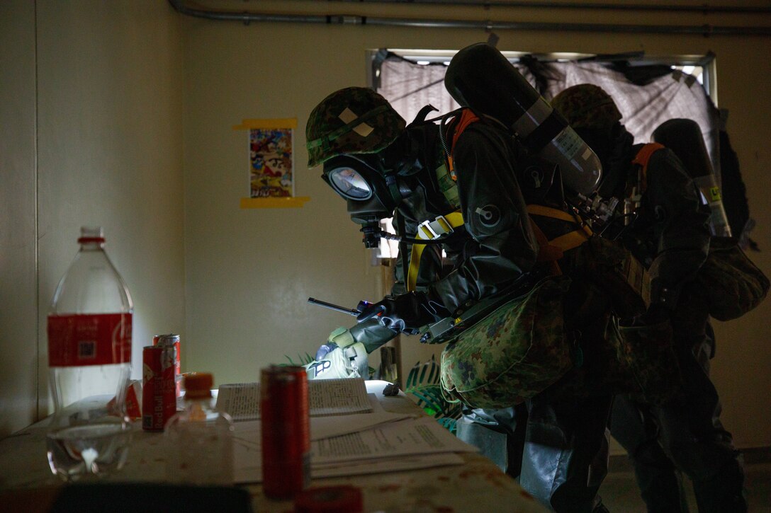 Japan Ground Self-Defense Force members with the 13th Brigade, Middle Army, perform a render safe procedure for a simulated improvised explosive device during a joint technical exchange at Marine Corps Air Station Iwakuni, Japan, March. 24, 2025. U.S. Marines from MCAS Iwakuni and JGSDF members with the 13th Brigade, Middle Army conducted a joint technical exchange to enhance their capabilities as a combined force in the Indo-Pacific. (U.S. Marine Corps photo by Lance Cpl. David Getz)