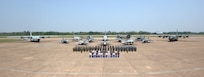 Distinguished visitors and Airmen from the Royal Thai Air Force, the U.S. Air Force, and the Republic of Singapore Air Force pose for a group photo after the Cope Tiger 25 closing ceremony at Korat Royal Air Base, Thailand Mar. 28, 2025.