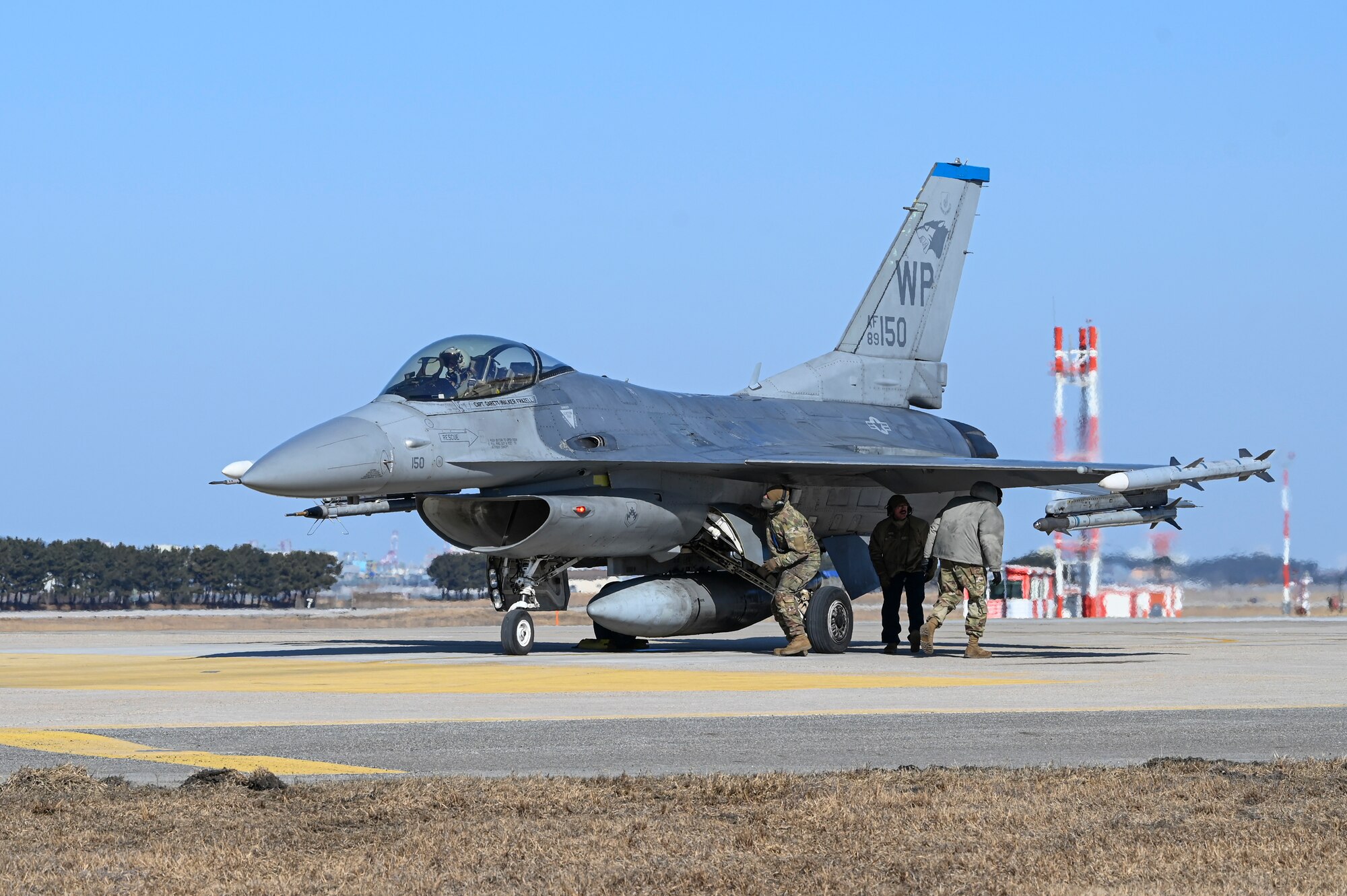 Airmen assigned to the 35th Fighter Generation Squadron execute hot pit refueling on an F-16 Fighting Falcon aircraft during an operational surge.