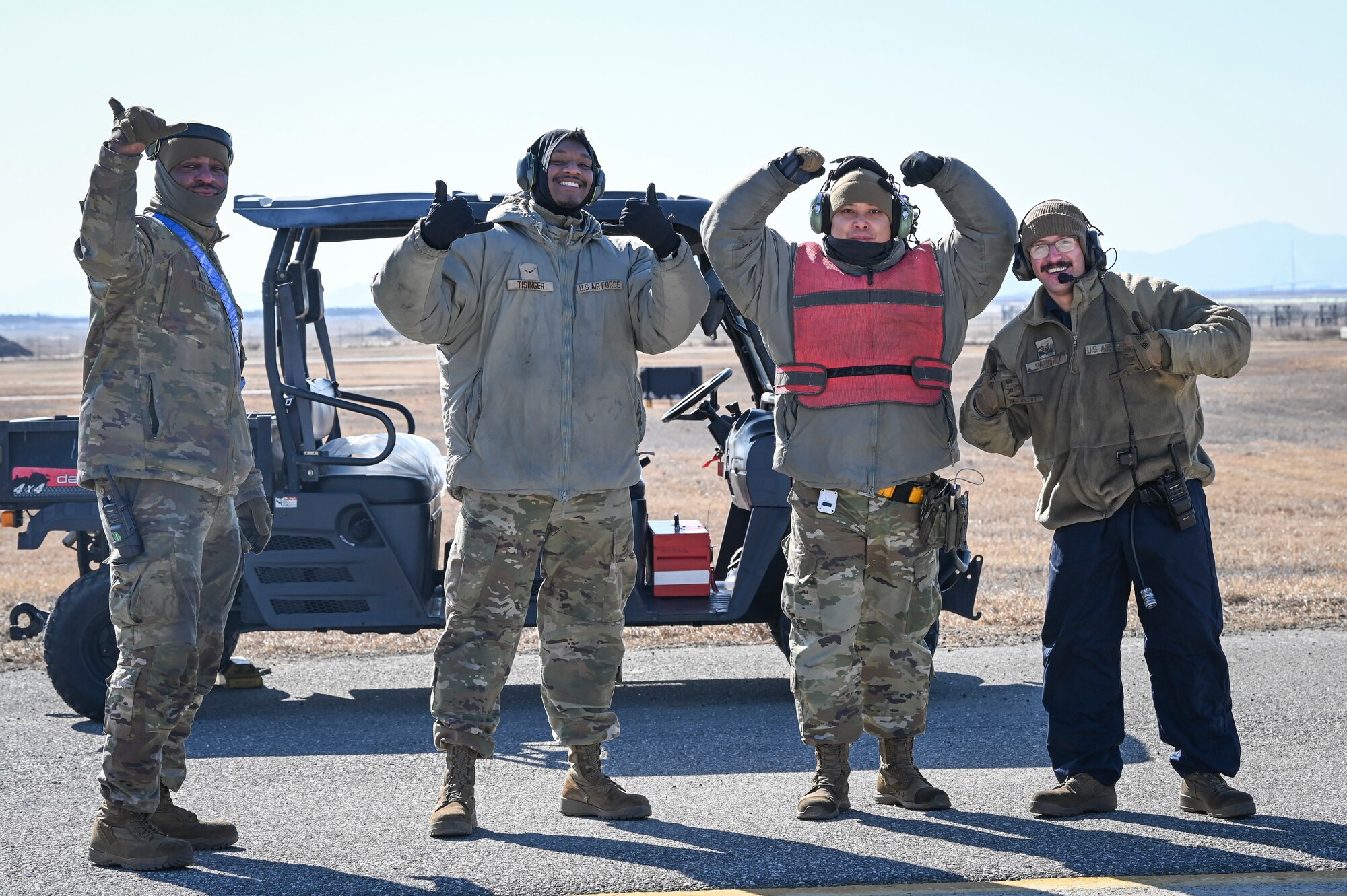 Airmen assigned to the 35th Fighter Generation Squadron pose with their unit’s motto designation during an operational surge.