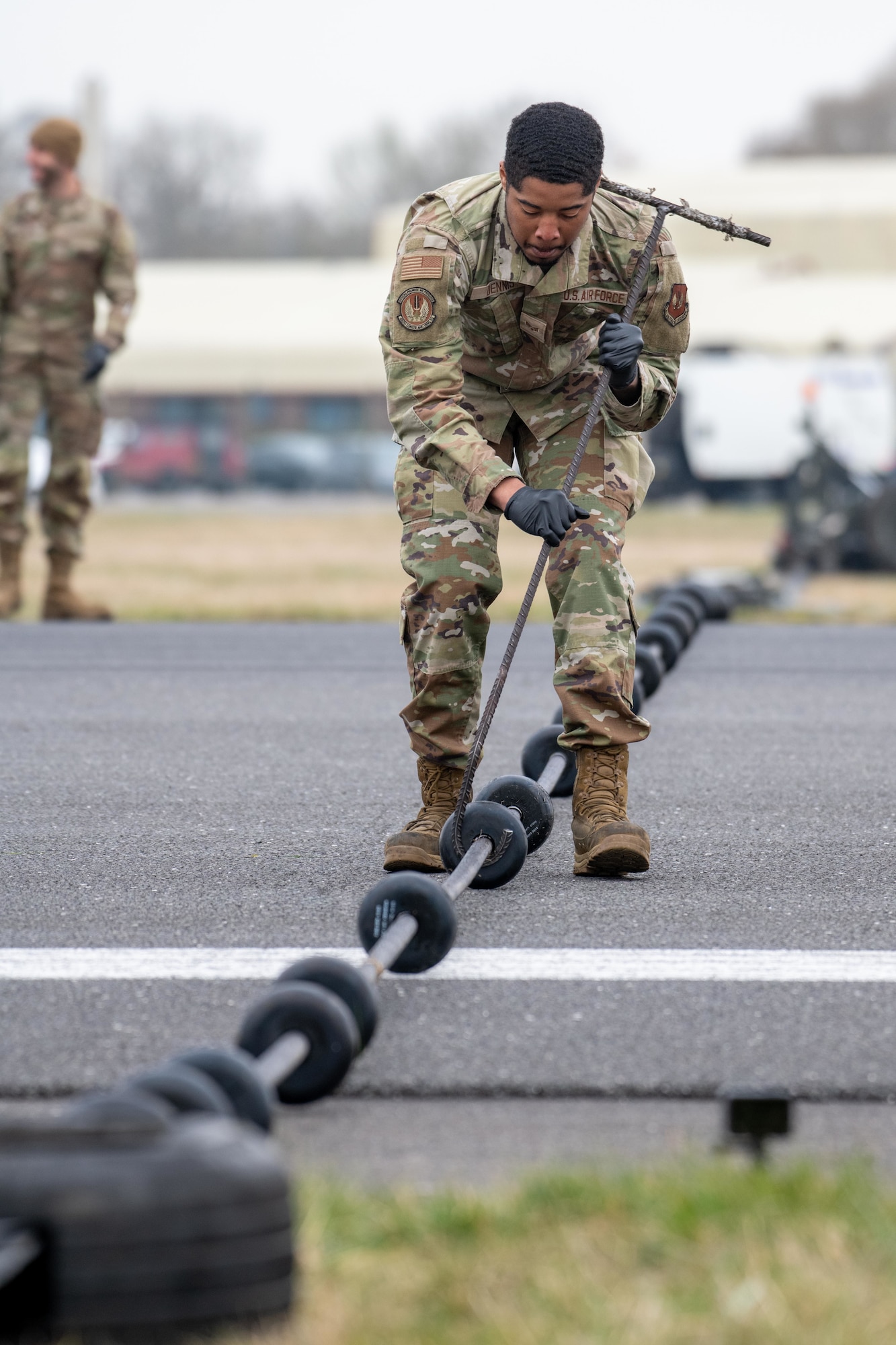 An Airman spaces donuts on a Mobile Aircraft Arresting System