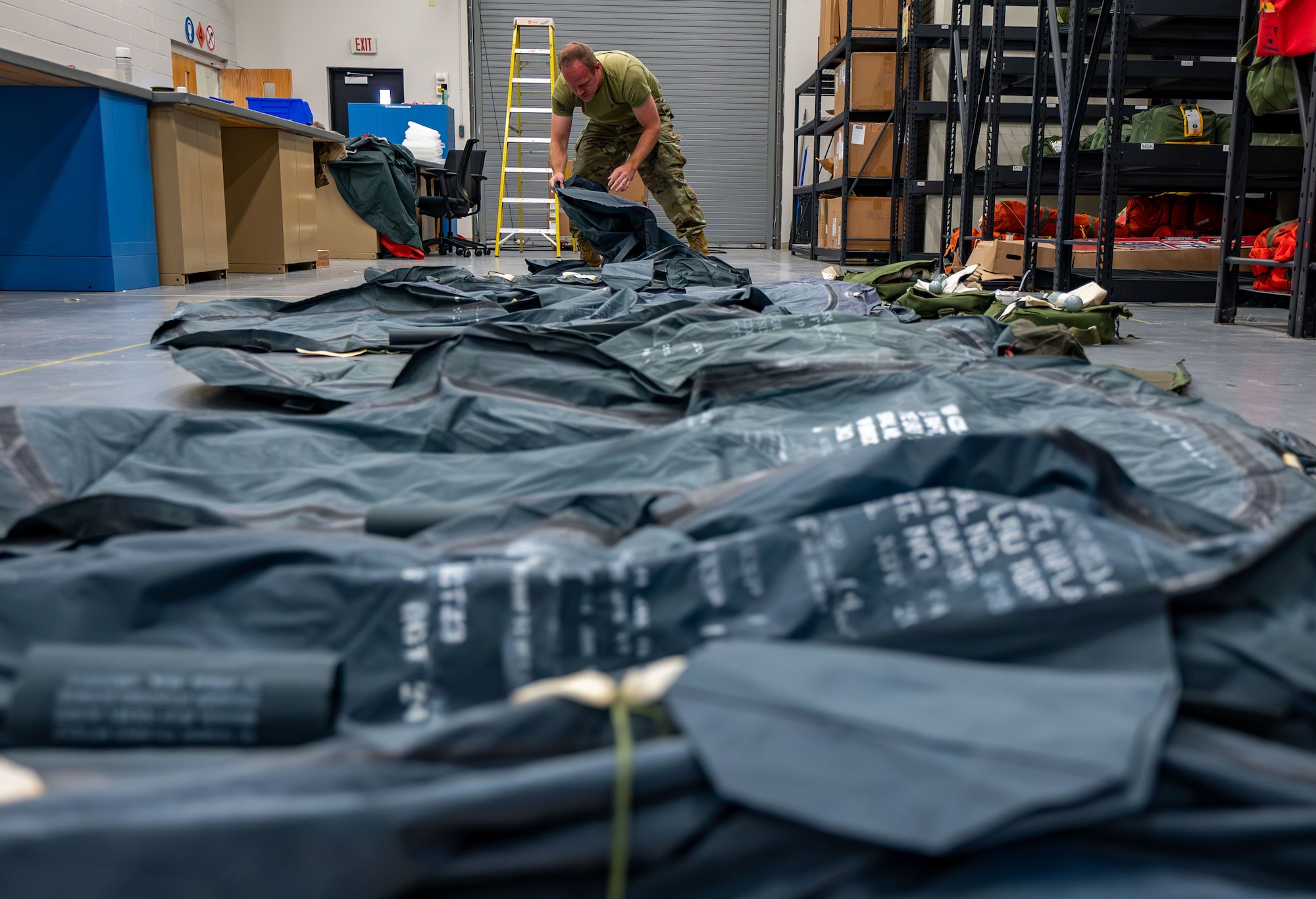 Staff Sgt. Corey Coats repacks an ML-4 one-man life raft