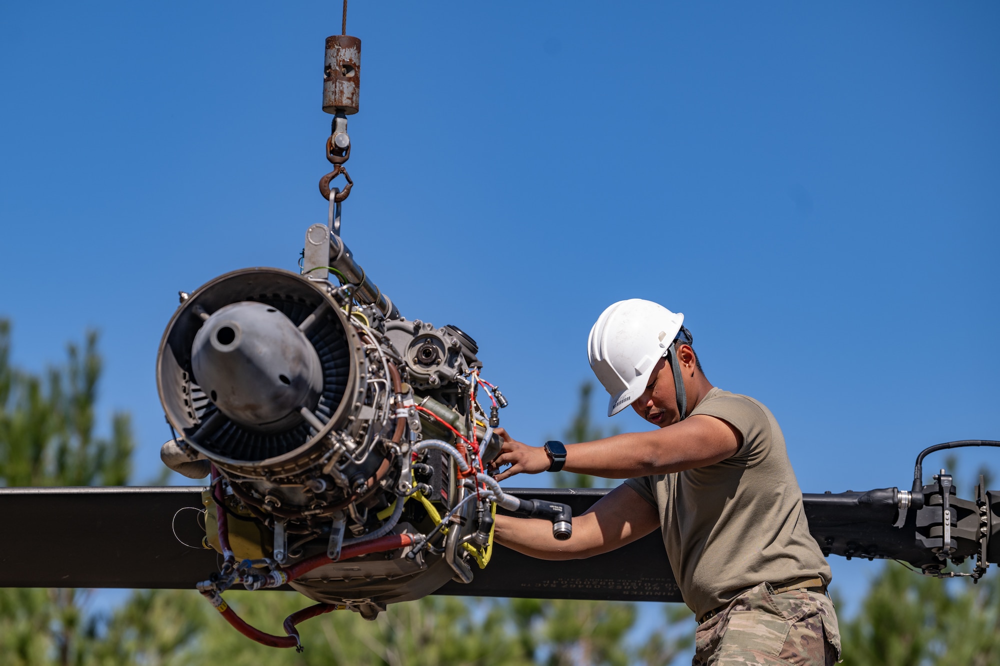 An Airman is working on an engine.