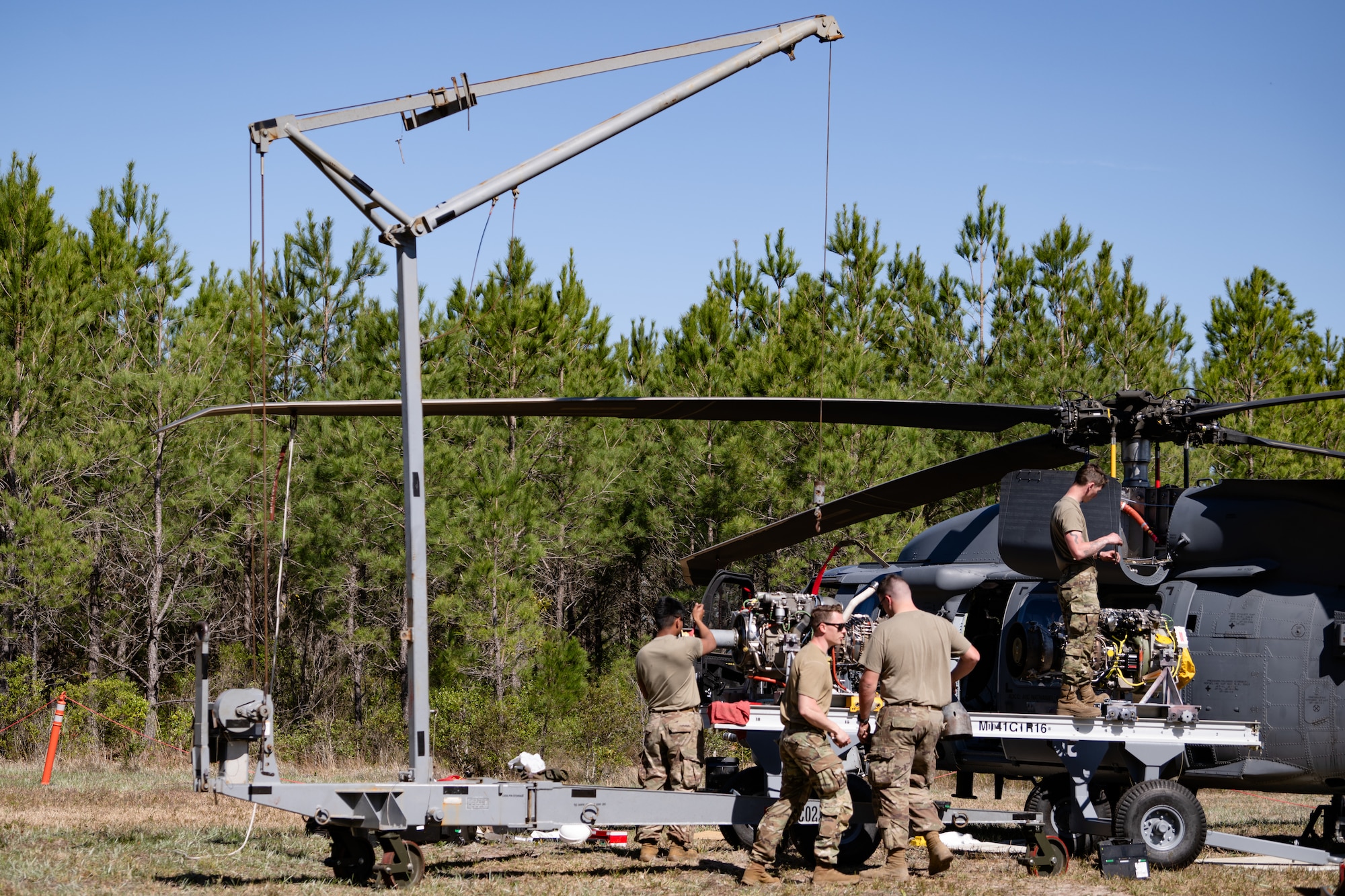 An engine is being removed from an HH-60.