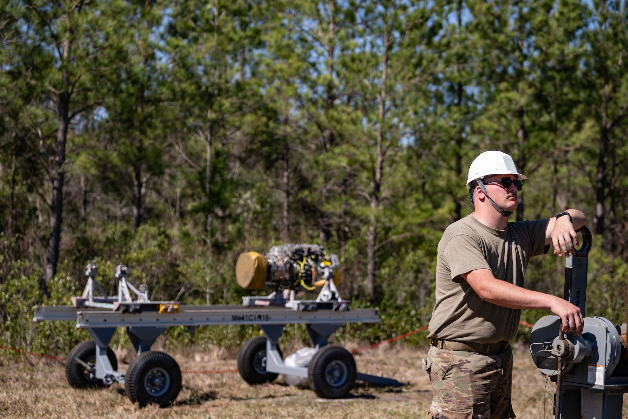 An Airman is fixing an engine.
