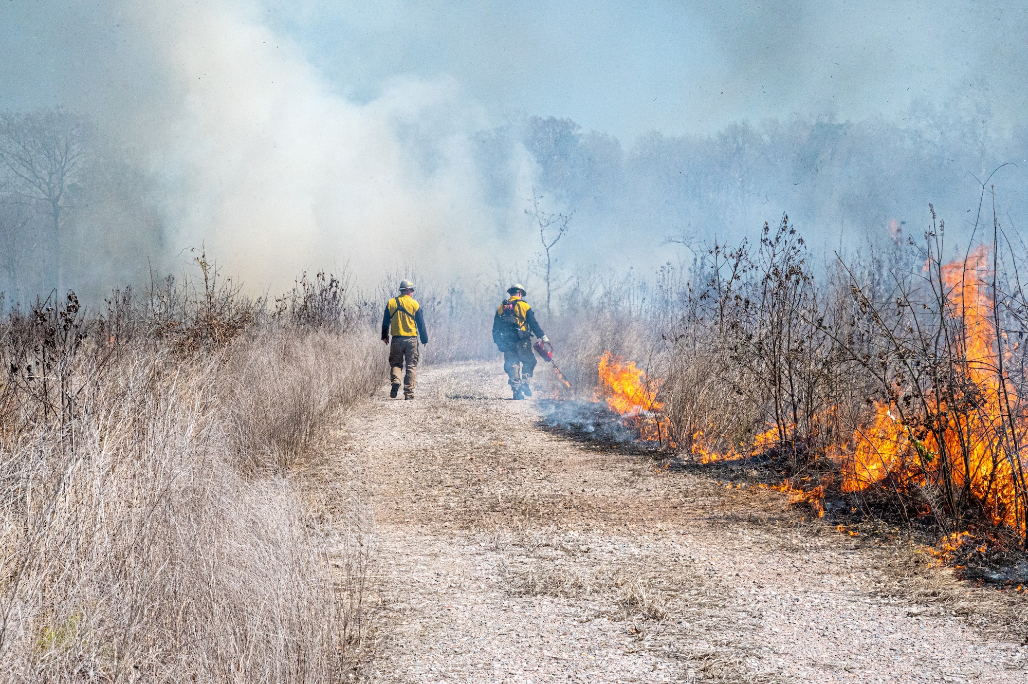 Firefighters walk down the road