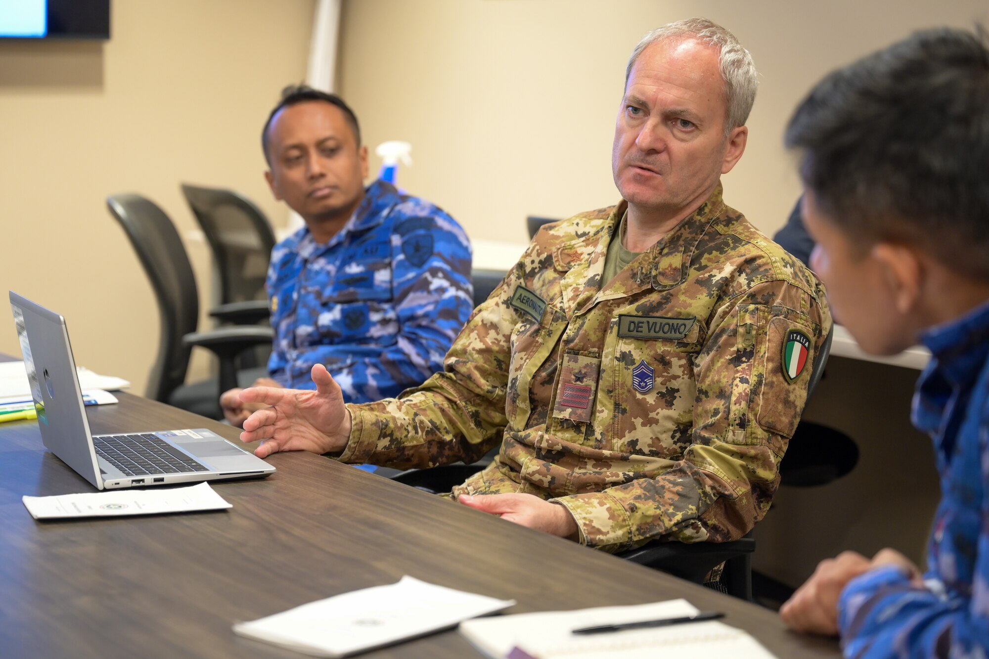 A photo of foreign air battle managers talking.