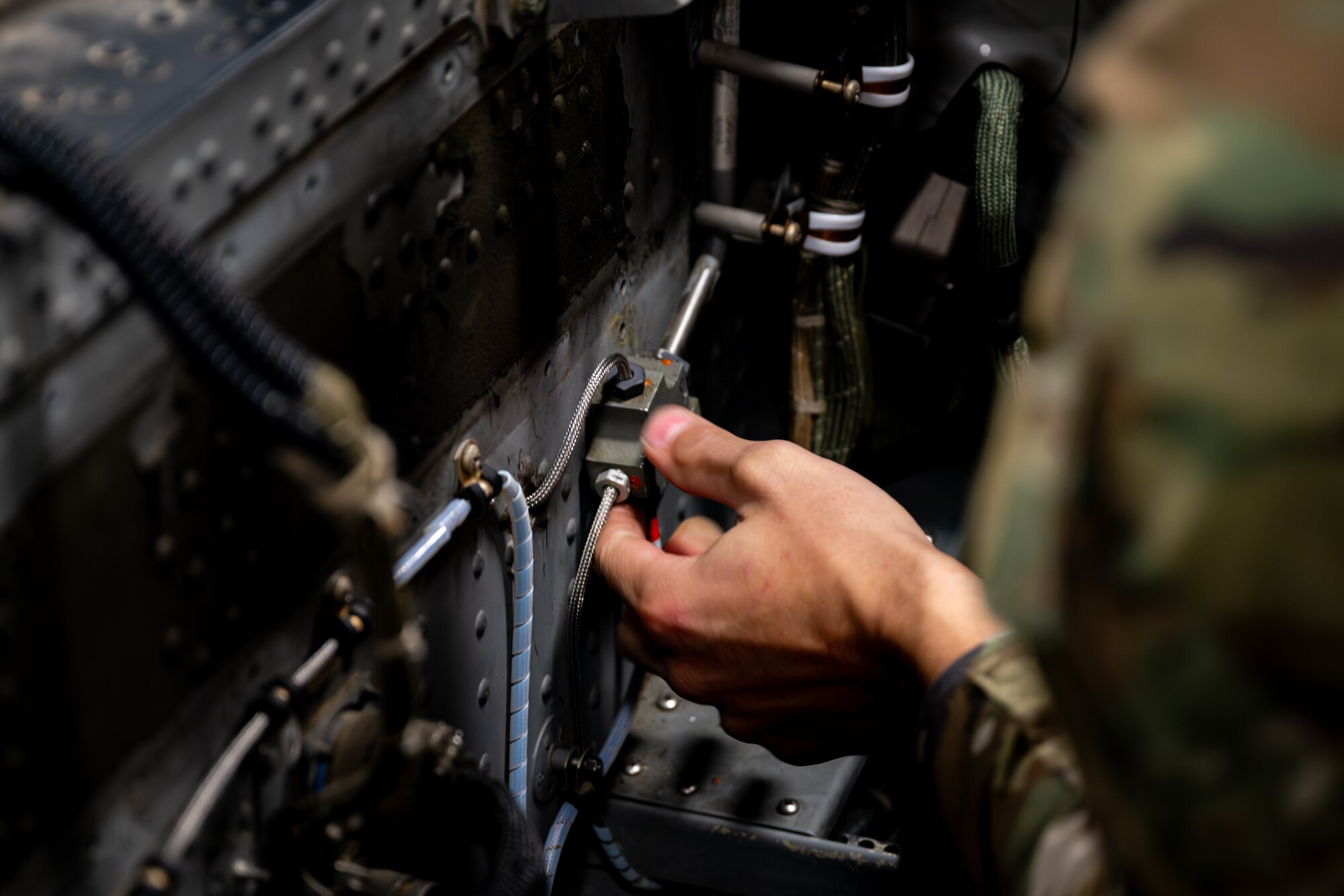 Airman performs maintenance on a F-16