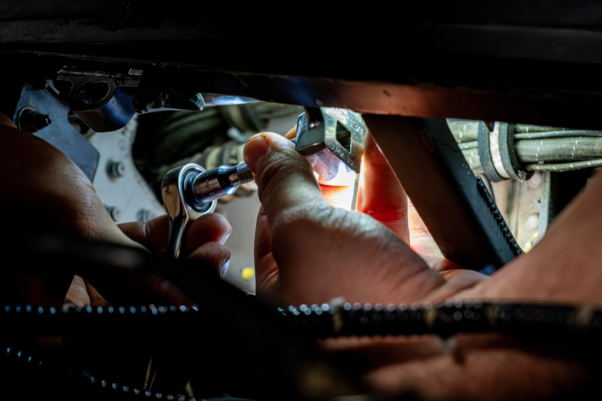 Airman performs maintenance on an F-16