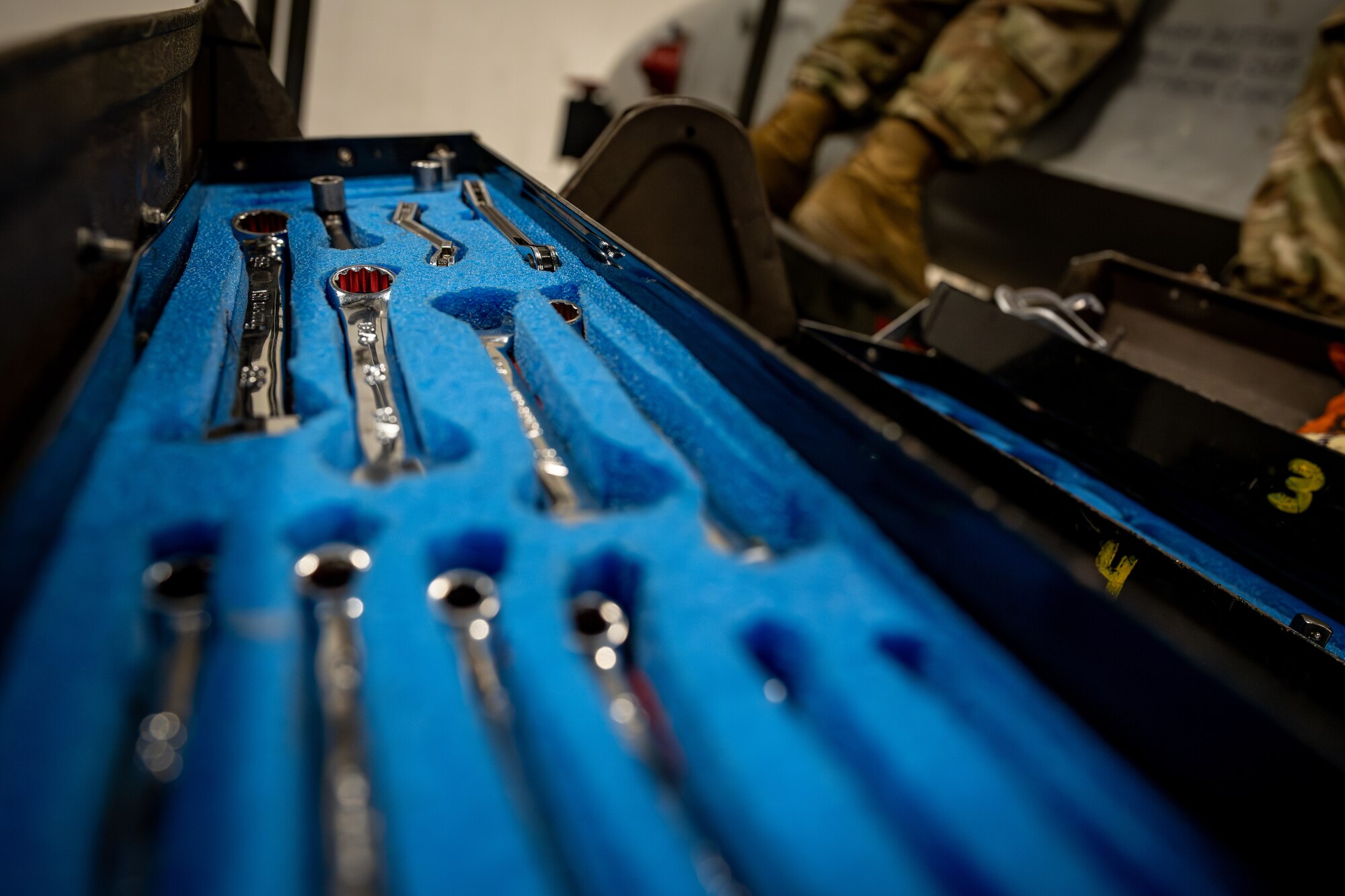Airman performs maintenance on an F-16