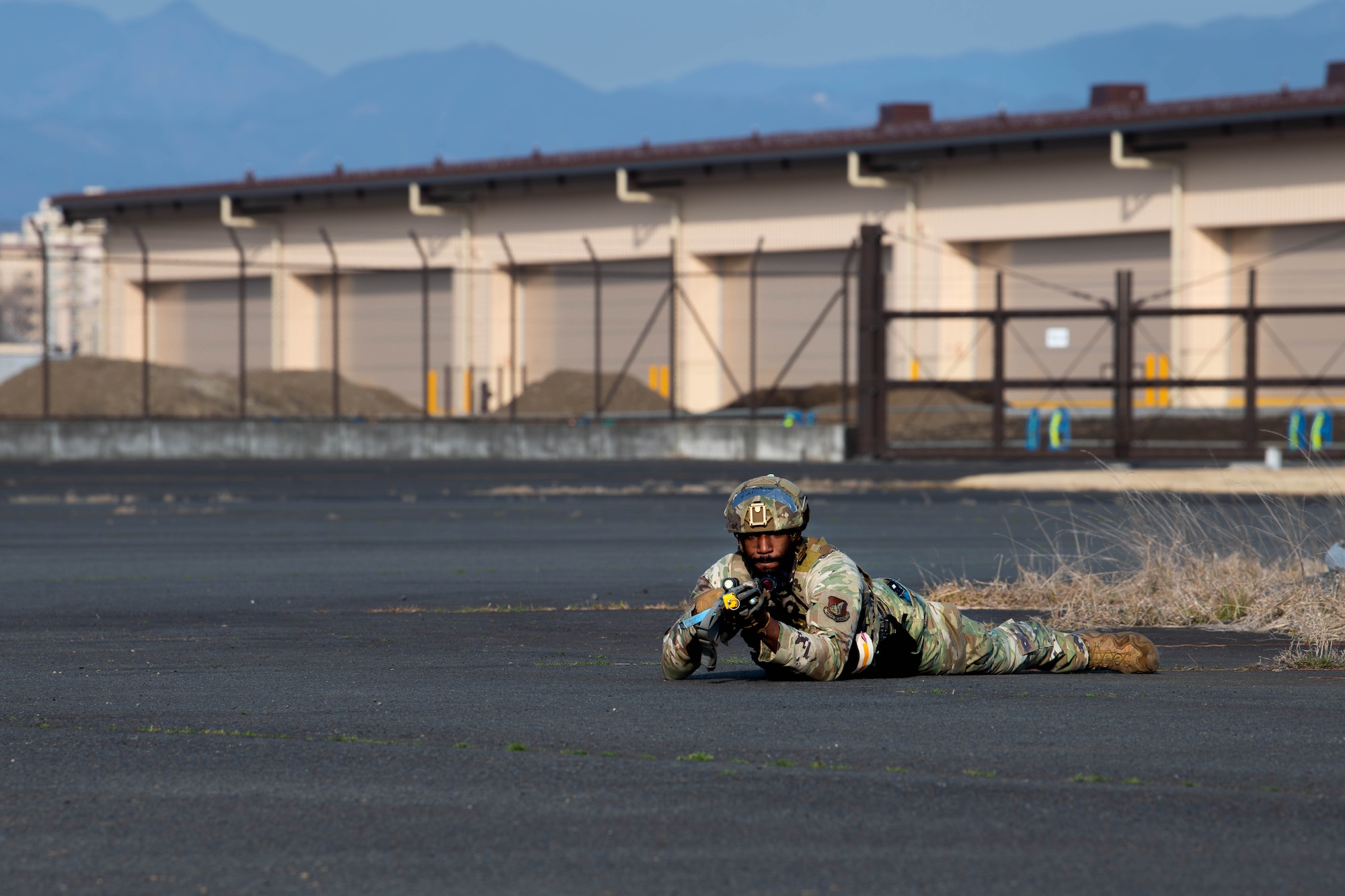 U.S. Air Force Senior Airman Keenan Mathews, 374 Security Forces Squadron patrolman, guards a simulated C-130J Super Hercules.