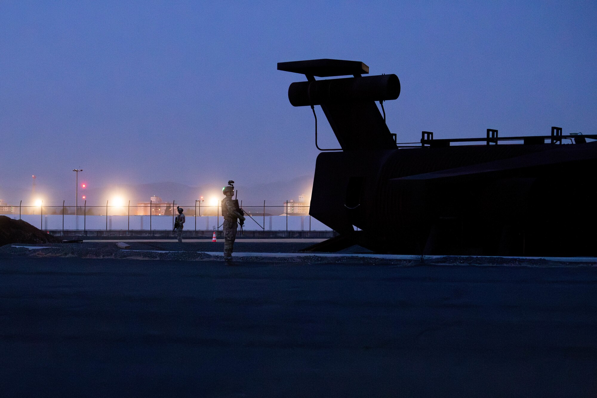 Defenders assigned to the 374 Security Forces Squadron guard a simulated C-130J Super Hercules.