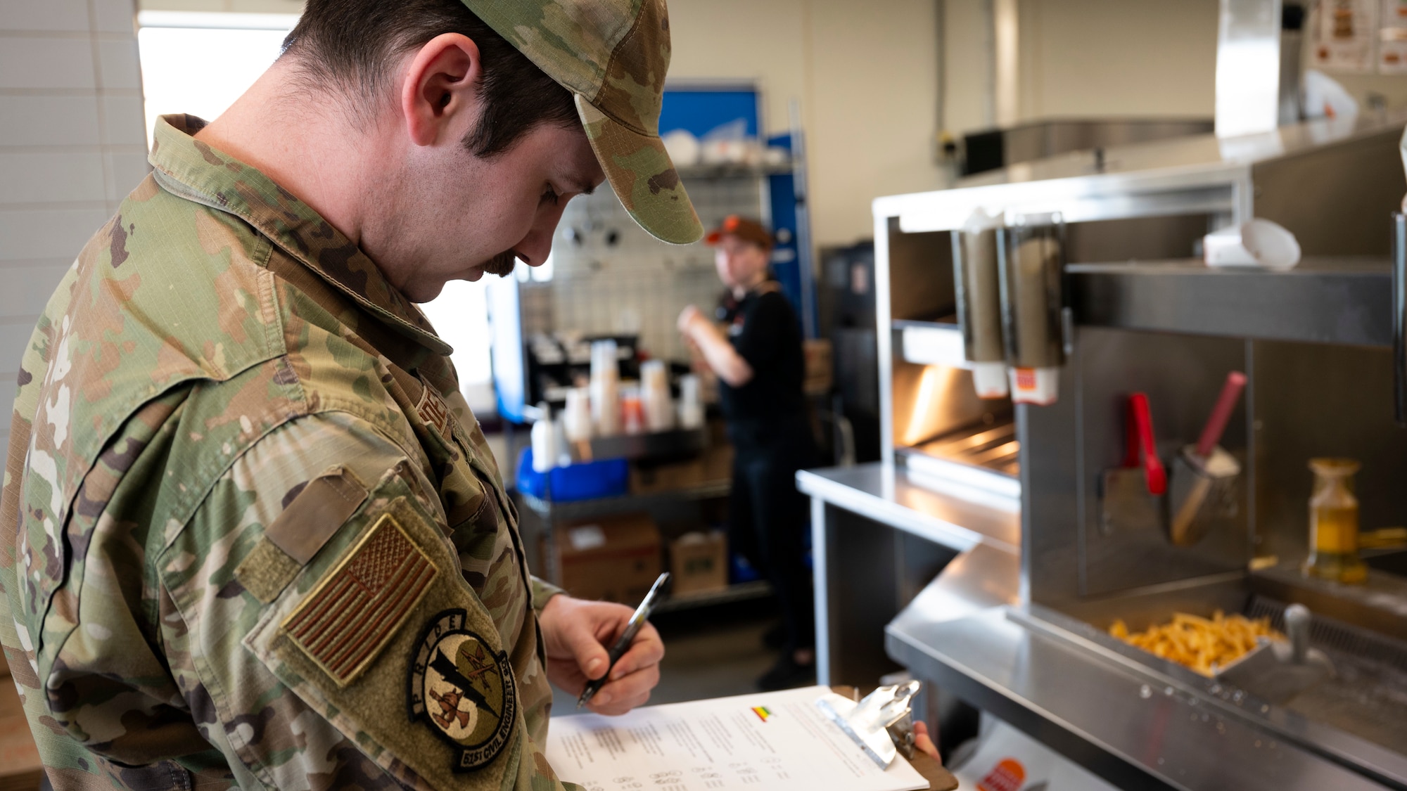 U.S. Air Force Senior Airman Aaron Burdette, 51st Civil Engineer Squadron pest manager, conducts a quality of living evaluation at Osan Air Base, Republic of Korea, April 1, 2025. Restaurants on base receive regular inspections by the 51st CES to ensure food service areas are maintaining a positive quality of life and protecting the health of service members and their families. (U.S. Air Force photo by Senior Airman Rome Bowermaster)