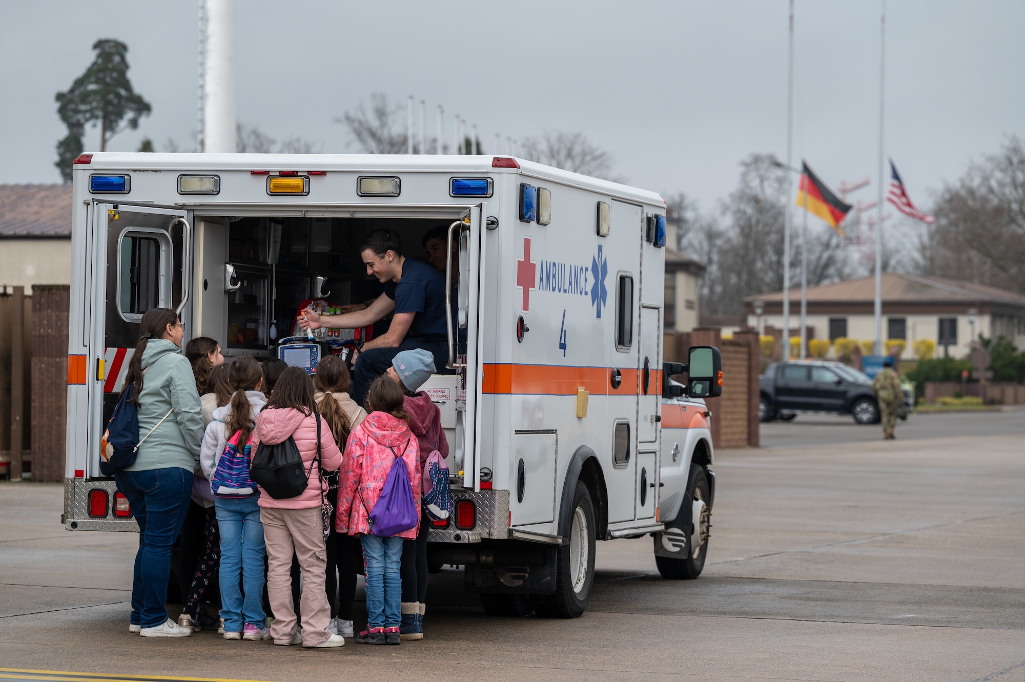 students interact with an EMT outside of an ambulance