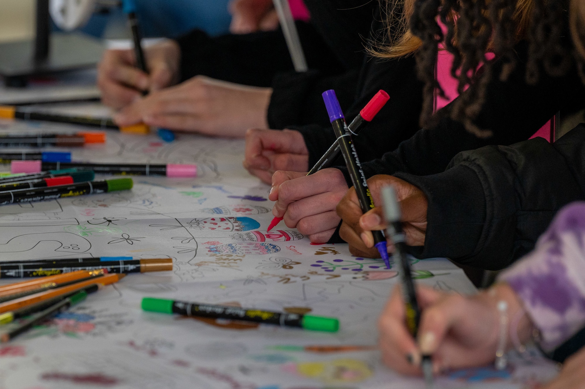 students are drawing at an exhibit
