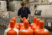 Machinist’s Mate (Nuclear) 2nd Class Dylan Hamilton, assigned to reactor department aboard the world’s largest aircraft carrier, USS Gerald R. Ford (CVN 78), moves refrigerant with a pallet jack in the hangar bay, March 31, 2025.