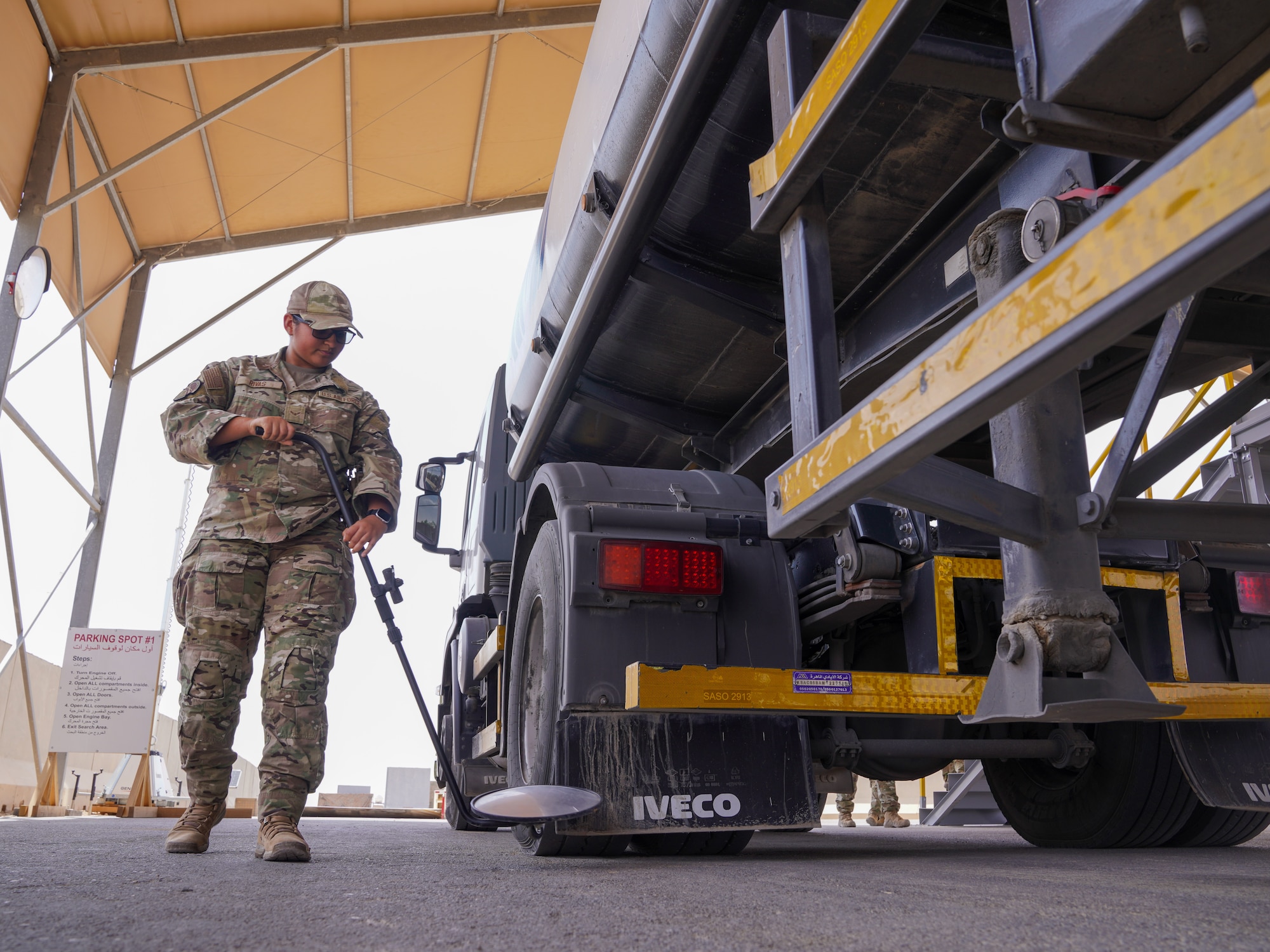 U.S. Air Force Airman 1st Class Jazmine Rivas, 378th Expeditionary Security Forces Squadron visitor control center member, uses a mirror to inspect the underside of a commercial vehicle in the U.S. Central Command area of responsibility, March 31, 2025.