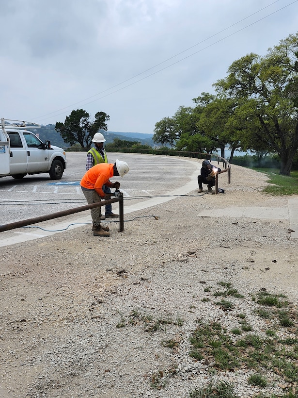 Work at Canyon Lake's Overlook Park includes a pipe rail fence around the entire parking area and four security gates