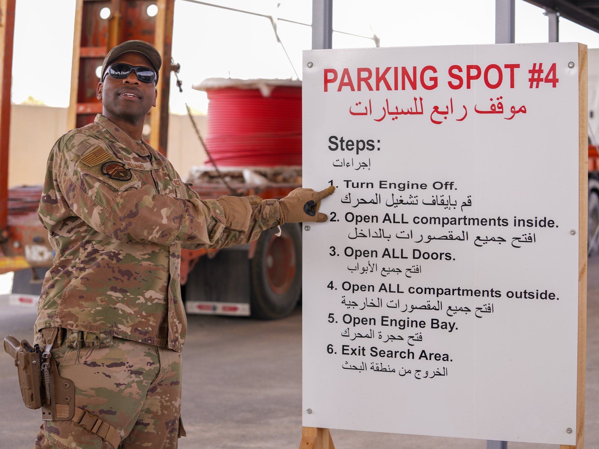 U.S. Air Force Staff Sgt. Richard Williams, 378th Expeditionary Security Forces Squadron visitor control center leader, demonstrates the steps drivers must follow when entering the vehicle search area in the U.S. Central Command area of responsibility, April 1, 2025.