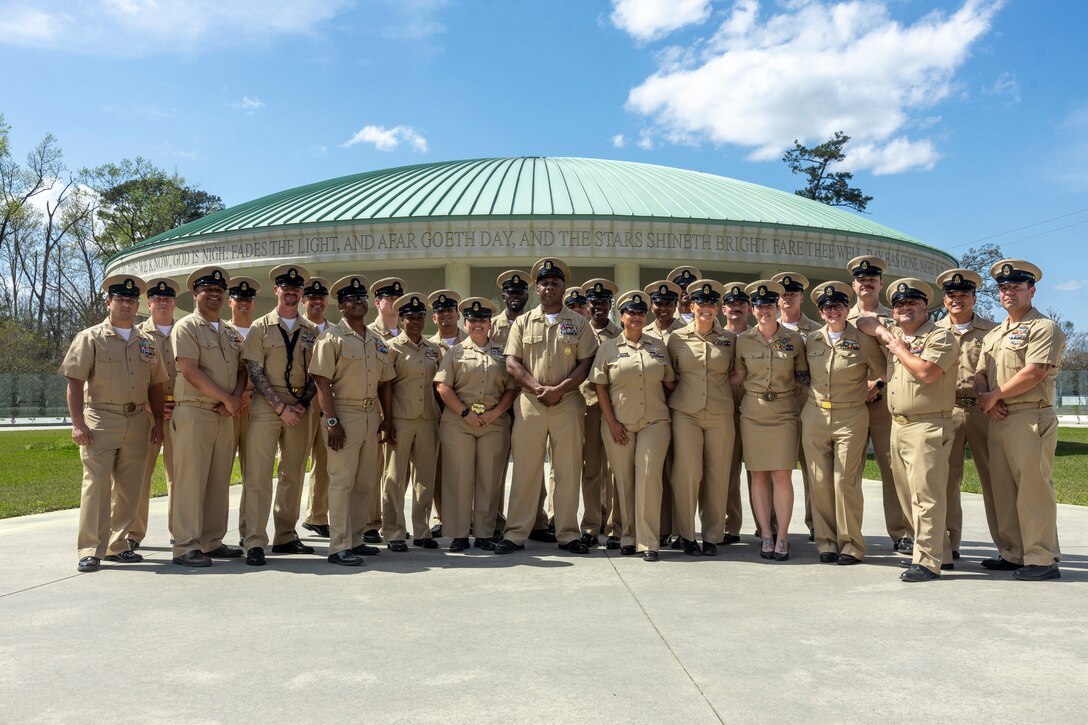 U.S. Navy Master Chief Petty Officer Joseph Johnson, 2nd Marine Logistics Group command master chief, center, poses for a photo with the chief petty officers of 2nd Medical Battalion, 2nd MLG, at Lejeune Memorial Gardens, Jacksonville, North Carolina, April 1, 2025. 2nd Medical Battalion celebrated the 132nd birthday of the rank of Chief Petty Officer by holding a tour of the Lejeune Memorial Gardens to commemorate and honor the legacy of those who served before them. (U.S. Marine Corps photo by Lance Cpl. Isabella Ramos)