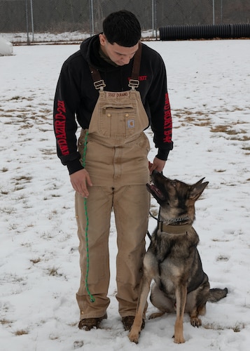Image of airman with dog