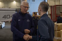 Admiral (ret.) Samuel Locklear III, a distinguished visitor (DV) aboard the world’s largest aircraft carrier, USS Gerald R. Ford (CVN 78), receives a challenge coin from Captain Mark Lawrence, Commodore, Destroyer Squadron (DESRON) 2, while touring the ship, March 29, 2025.