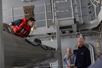 Boatswain’s Mate 3rd Class Brodie Winstead (left), assigned to deck department aboard the world's largest aircraft carrier, USS Gerald R. Ford (CVN 78), discusses the ship’s rigid hull inflatable boats (RHIB) with Distinguished Visitor (DV) Admiral (ret.) Samuel Locklear III during a tour of the ship, March 29, 2025.