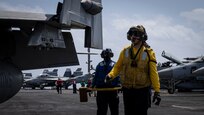 Aviation Boatswain's Mate (Handling) 2nd Class Cody Stenger, assigned to air department aboard the world's largest aircraft carrier, USS Gerald R. Ford (CVN 78), directs an F/A-18F Super Hornet attached to the "Blacklions" of Strike Fighter Squadron (VFA) 213 on the flight deck, March 29, 2025.