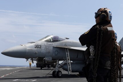Aviation Structural Mechanic (Equipment) Airman Preibprom Parks, assigned to the "Blacklions" of Strike Fighter Squadron (VFA) 213, observes flight operations on the flight deck of the world's largest aircraft carrier, USS Gerald R. Ford (CVN 78), March 29, 2025.