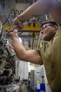 Aviation Machinist’s Mate Airman Recruit Noah Figueroa, assigned to aviation intermediate maintenance department aboard the world’s largest aircraft carrier, USS Gerald R. Ford (CVN 78), performs maintenance on a jet engine, March 29, 2025.