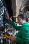 Aviation Machinist’s Mate 2nd Class Leslie Perez, assigned to the “Golden Warriors” of Strike Fighter Squadron (VFA) 87, performs maintenance on a jet engine in the jet engine shop aboard the world’s largest aircraft carrier, USS Gerald R. Ford (CVN 78), March 29, 2025.