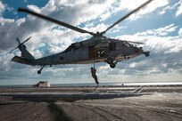 U.S. Navy Explosive Ordnance Disposal Technicians assigned to Explosive Ordnance Disposal Mobile Unit (EODMU) 12 fast rope from an MH-60S Sea Hawk, attached to the "Tridents" of Helicopter Sea Combat Squadron (HSC) 9, onto the flight deck of the world's largest aircraft carrier, USS Gerald R. Ford (CVN 78), March 28, 2025.