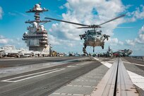 Sailors assigned to Explosive Ordnance Disposal Mobile Unit (EODMU) 12 fast rope from an MH-60S Sea Hawk, attached to the "Tridents" of Helicopter Sea Combat Squadron (HSC) 9, onto the flight deck of the world's largest aircraft carrier, USS Gerald R. Ford (CVN 78), March 28, 2025.
