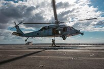 Sailors assigned to Explosive Ordnance Disposal Mobile Unit (EODMU) 12 fast rope from an MH-60S Sea Hawk, attached to the "Tridents" of Helicopter Sea Combat Squadron (HSC) 9, onto the flight deck of the world's largest aircraft carrier, USS Gerald R. Ford (CVN 78), March 28, 2025.