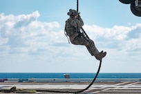 Sailors assigned to Explosive Ordnance Disposal Mobile Unit (EODMU) 12 fast rope from an MH-60S Sea Hawk, attached to the "Tridents" of Helicopter Sea Combat Squadron (HSC) 9, onto the flight deck of the world's largest aircraft carrier, USS Gerald R. Ford (CVN 78), March 28, 2025.