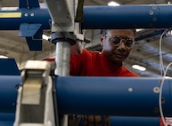 Aviation Ordnanceman 1st Class Ebone Crawford, assigned to weapons department aboard the world’s largest aircraft carrier, USS Gerald R. Ford (CVN 78), inspects training ammo in the weapons transfer area, March 27, 2025.