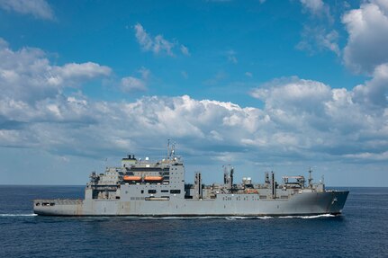 The Lewis and Clark-class dry cargo ship USNS William McLean (T-AKE 12) transits the Atlantic Ocean next to the world's largest aircraft carrier, USS Gerald R. Ford (CVN 78), March 27, 2025.