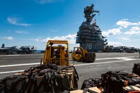 Sailors assigned to weapons department move cargo during a vertical replenishment (VERTREP) on the flight deck of the world's largest aircraft carrier, USS Gerald R. Ford (CVN 78), March 27, 2025.