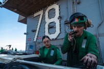 Aviation Structural Mechanic 3rd Class Brandon Kenney (right) and Aviation Structural Mechanic Seaman Yaritza Tena, both assigned to aviation intermediate maintenance department aboard the world's largest aircraft carrier, USS Gerald R. Ford (CVN 78), troubleshoot ground support equipment on the flight deck during a vertical replenishment (VERTREP), March 27, 2025.