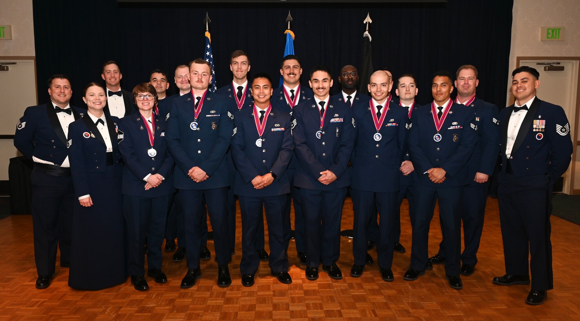 Graduates, instructors, and mentors pose for a group photo.